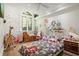 Charming ' room featuring decorative stained glass windows, stuffed animals and a playful unicorn themed bedspread at 200 Grand Blvd, Tarpon Springs, FL 34689