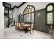 Elegant dining room with large stained-glass window, black spiral staircase, and wood table at 200 Grand Blvd, Tarpon Springs, FL 34689