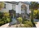 A unique house with pillars, garden landscaping and mature trees, creating a picturesque and inviting atmosphere at 200 Grand Blvd, Tarpon Springs, FL 34689
