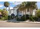 A distinctive house featuring classic architecture, with palm trees accentuating its unique design and appeal at 200 Grand Blvd, Tarpon Springs, FL 34689