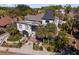 Bird's eye view of an ornate home with black-and-white accents, a dark roof, and a lush yard with palm trees at 200 Grand Blvd, Tarpon Springs, FL 34689
