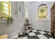 Elegant hallway with arched windows, stained glass, and black and white checkered marble flooring at 200 Grand Blvd, Tarpon Springs, FL 34689