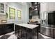 Kitchen with marble countertops, stainless steel appliances, and a view of stained glass windows at 200 Grand Blvd, Tarpon Springs, FL 34689
