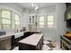 Kitchen with an island and marble countertop, stainless steel appliances, and stained glass windows at 200 Grand Blvd, Tarpon Springs, FL 34689