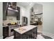 Open kitchen with an island, stainless steel appliances, and an ornate range hood at 200 Grand Blvd, Tarpon Springs, FL 34689