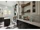 A kitchen area with black and white checkered flooring, and granite counters offering a timeless aesthetic at 200 Grand Blvd, Tarpon Springs, FL 34689
