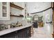 Open kitchen and living room featuring a marble countertop and modern shelving at 200 Grand Blvd, Tarpon Springs, FL 34689