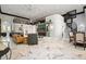 A spacious living area showcasing the open floor plan, marble floors, and a spiral staircase leading to a loft at 200 Grand Blvd, Tarpon Springs, FL 34689