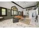 A spacious living room area featuring stained glass windows, a cozy seating area, and a high ceiling at 200 Grand Blvd, Tarpon Springs, FL 34689