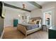 Spacious main bedroom with hardwood floors, ceiling beams, neutral decor, and plenty of natural light at 200 Grand Blvd, Tarpon Springs, FL 34689
