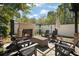 Inviting backyard fireplace area with stone patio and comfortable seating, great for outdoor gatherings at 200 Grand Blvd, Tarpon Springs, FL 34689