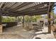 Inviting outdoor patio with a bar, dining area, fireplace, and lush landscaping perfect for entertaining at 200 Grand Blvd, Tarpon Springs, FL 34689