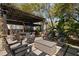 Spacious outdoor area featuring a covered patio with fireplace and television for backyard entertainment at 200 Grand Blvd, Tarpon Springs, FL 34689
