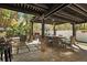 A shaded patio offers an inviting fireplace with comfortable seating and lush landscaped views at 200 Grand Blvd, Tarpon Springs, FL 34689