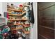 Well-stocked walk-in pantry featuring custom shelves for organized storage and easy access at 200 Grand Blvd, Tarpon Springs, FL 34689