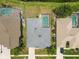 Aerial view of a home with a screened-in pool and well-maintained landscaping at 22129 Yachtclub Ter, Land O Lakes, FL 34639