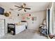 Bedroom featuring a black bed frame, a ceiling fan, a dresser and decorated walls at 22129 Yachtclub Ter, Land O Lakes, FL 34639