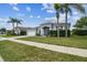 Beautiful single-story home with a well-kept lawn, mature trees, and an inviting entrance, located in a Gathering-friendly neighborhood at 22129 Yachtclub Ter, Land O Lakes, FL 34639