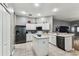 Well-lit kitchen features stainless steel appliances, white cabinets, and a functional center island at 22129 Yachtclub Ter, Land O Lakes, FL 34639