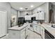 Kitchen showcases white cabinetry, stainless steel refrigerator, and functional center island at 22129 Yachtclub Ter, Land O Lakes, FL 34639