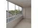 Screened balcony offers outdoor space with a view of the surrounding trees at 2333 Feather Sound Dr # A208, Clearwater, FL 33762