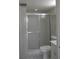 Bathroom featuring a shower with sliding glass doors, toilet, and vanity at 2333 Feather Sound Dr # A208, Clearwater, FL 33762