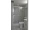 Bathroom featuring a shower with sliding glass doors, toilet, and vanity at 2333 Feather Sound Dr # A208, Clearwater, FL 33762