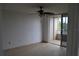 A bright bedroom with tile flooring, ceiling fan and access to a private balcony at 2333 Feather Sound Dr # A208, Clearwater, FL 33762