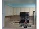 Well-lit kitchen featuring stainless steel appliances and cream colored cabinets at 2333 Feather Sound Dr # A208, Clearwater, FL 33762
