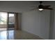 Living room features tile flooring, ceiling fan, and access to balcony at 2333 Feather Sound Dr # A208, Clearwater, FL 33762