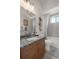 Charming bathroom with granite countertop vanity, decorative seahorse and bright window with shower/tub combo at 2375 Fairskies Dr, Spring Hill, FL 34606