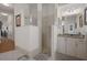 Bathroom features tiled shower with glass door, granite countertop and vanity with decorative mirrors at 2375 Fairskies Dr, Spring Hill, FL 34606