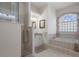 Bathroom with glass shower, soaking tub with tile surround, and vanity with granite countertop at 2375 Fairskies Dr, Spring Hill, FL 34606