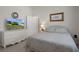 Light-filled bedroom features a bed, dresser with TV, and bright window with shutters at 2375 Fairskies Dr, Spring Hill, FL 34606