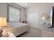 Light-filled bedroom with neutral tones features a double bed, closet and bright window with shutters at 2375 Fairskies Dr, Spring Hill, FL 34606