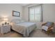 Light-filled bedroom with neutral tones features a double bed, closet and bright window with shutters at 2375 Fairskies Dr, Spring Hill, FL 34606