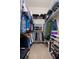 Walk-in closet with metal shelving and rod with clothes and shoes at 2375 Fairskies Dr, Spring Hill, FL 34606