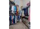 Walk-in closet with metal shelving and rod with clothes and drawers at 2375 Fairskies Dr, Spring Hill, FL 34606