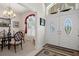 Elegant dining room with double door entrance, chandelier lighting, and decorative window at 2375 Fairskies Dr, Spring Hill, FL 34606