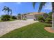 Charming single-story home with a wide paved driveway and a meticulously kept lawn at 2375 Fairskies Dr, Spring Hill, FL 34606