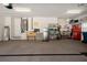 Organized garage with ample storage, shelving, water heater, and utility sink at 2375 Fairskies Dr, Spring Hill, FL 34606