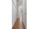 Hallway featuring wood flooring and white walls with white doors and trim at 2375 Fairskies Dr, Spring Hill, FL 34606