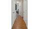 Hallway featuring wood flooring, white walls, and white doors with view to dresser at 2375 Fairskies Dr, Spring Hill, FL 34606