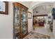 Hallway with decorative display case and view into the living room at 2375 Fairskies Dr, Spring Hill, FL 34606