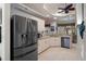 Bright kitchen with stainless steel appliances, granite countertops, and cream-colored cabinets at 2375 Fairskies Dr, Spring Hill, FL 34606