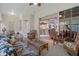 Cozy living room with access to the kitchen featuring rattan furniture and neutral carpeting at 2375 Fairskies Dr, Spring Hill, FL 34606