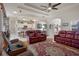 Open-concept living room and kitchen area with comfortable seating and an abundance of natural light at 2375 Fairskies Dr, Spring Hill, FL 34606