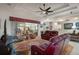Spacious open-concept living room featuring hardwood floors, comfortable seating, and abundant natural light at 2375 Fairskies Dr, Spring Hill, FL 34606