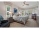 Spacious main bedroom with large windows, plantation shutters, and a ceiling fan at 2375 Fairskies Dr, Spring Hill, FL 34606
