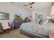 Bright main bedroom with a ceiling fan, dresser, and chair for relaxing at 2375 Fairskies Dr, Spring Hill, FL 34606